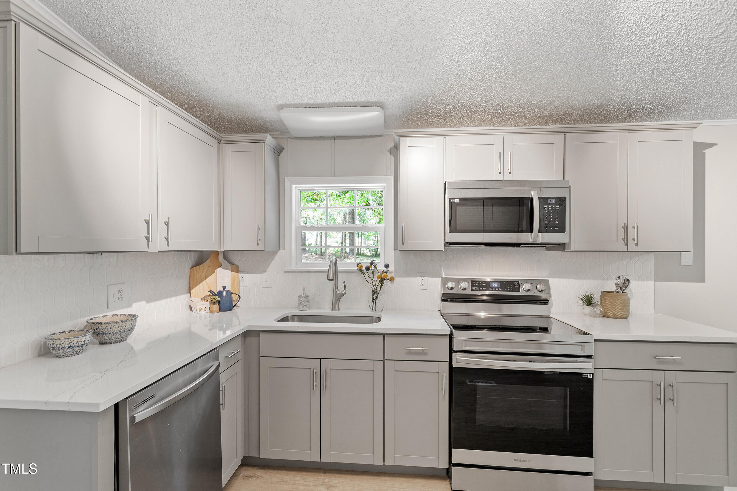 12237 Burgess Road Middlesex, NC 27557 - Photo 9 of 35 a kitchen with white cabinets appliances and a sink