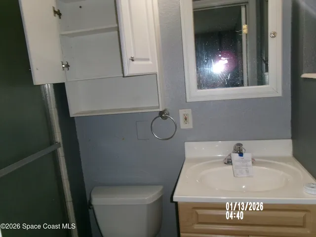 a kitchen with granite countertop a sink stove and cabinets
