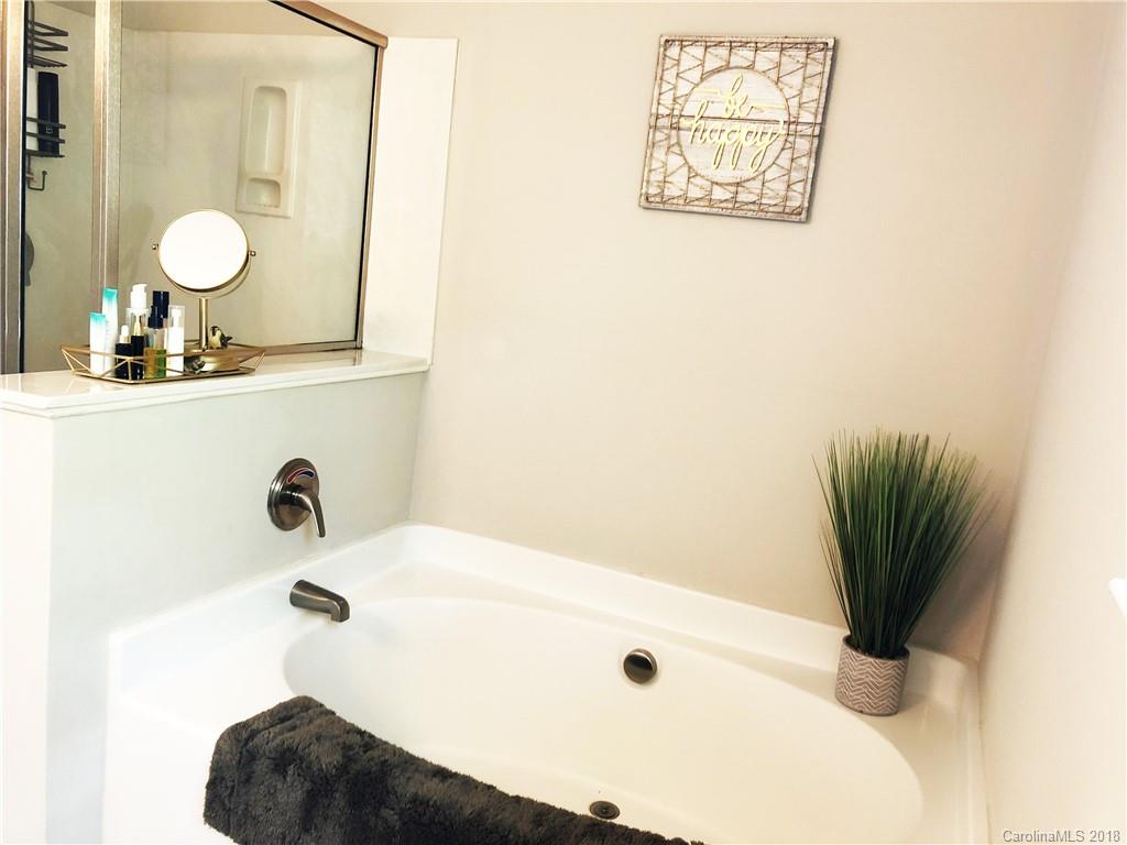 777 Jones Branch Road Fort Mill, SC 29715 - Photo 16 of 27 a bathroom with a tub sink and a mirror