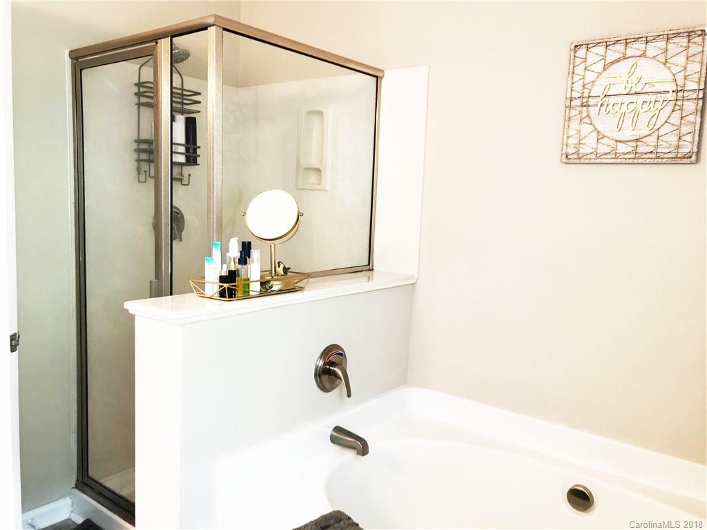 777 Jones Branch Road Fort Mill, SC 29715 - Photo 17 of 27 a bathroom with a tub a sink and a mirror