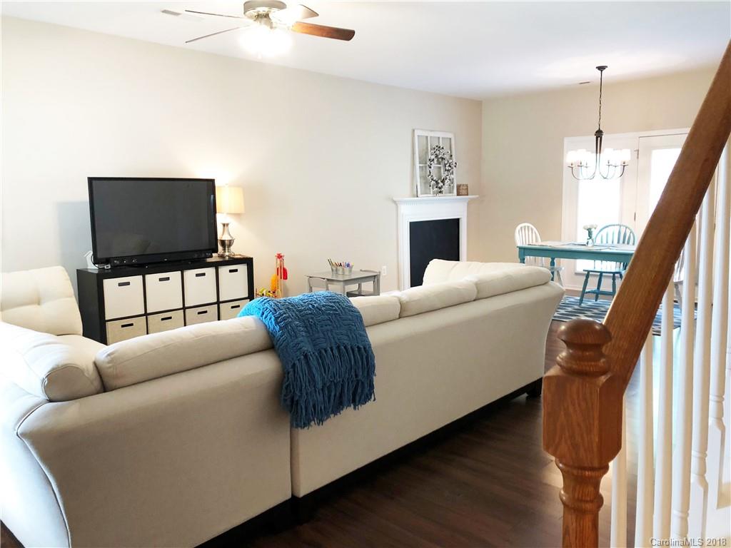 777 Jones Branch Road Fort Mill, SC 29715 - Photo 5 of 27 a living room with furniture a fireplace and a flat screen tv