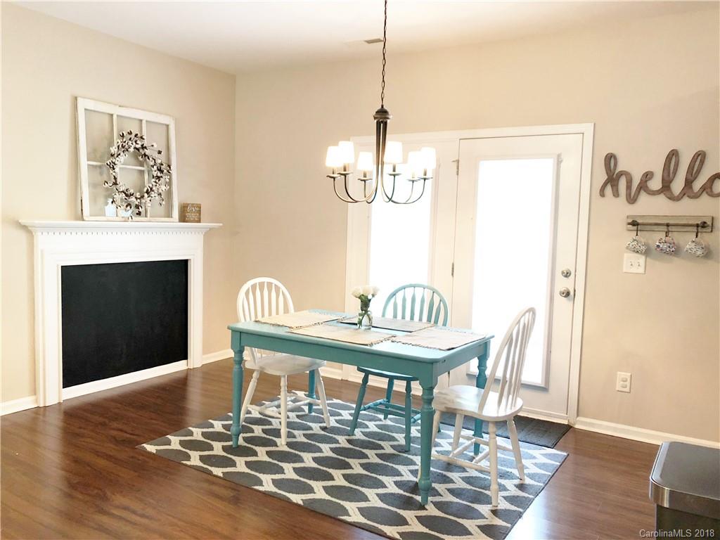 777 Jones Branch Road Fort Mill, SC 29715 - Photo 7 of 27 a dining room with furniture a chandelier and wooden floor