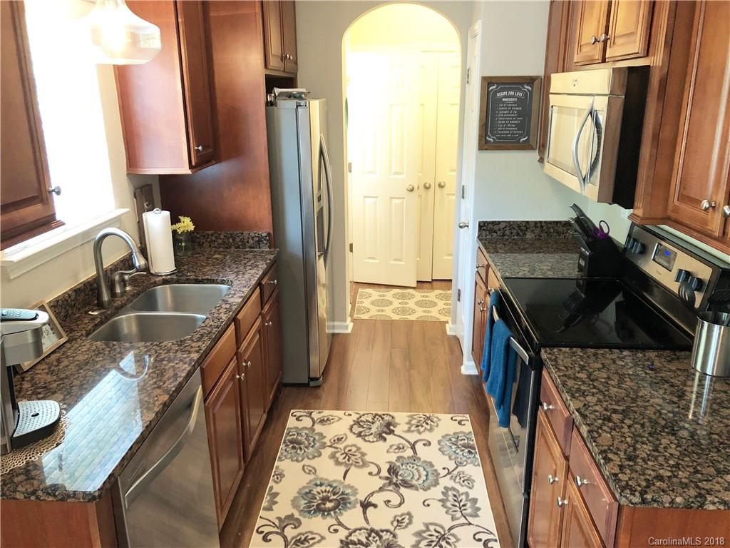 777 Jones Branch Road Fort Mill, SC 29715 - Photo 9 of 27 a kitchen with granite countertop a sink stove and refrigerator