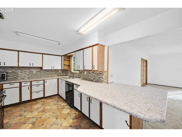 a kitchen with stainless steel appliances granite countertop a stove a sink and a granite counter tops