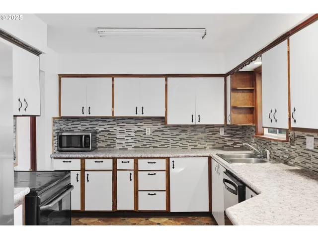 a kitchen with stainless steel appliances granite countertop a sink stove and cabinets