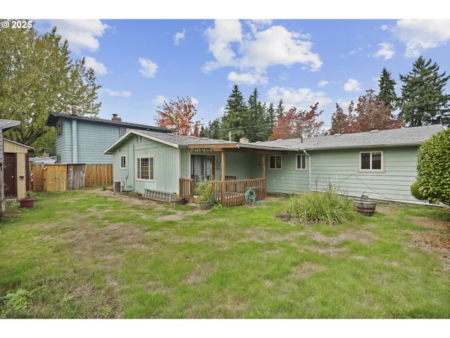 a backyard of a house with table and chairs