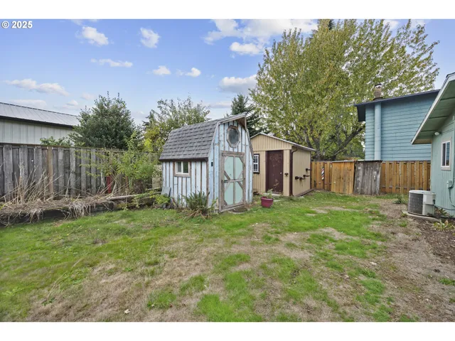 a backyard of a house with table and chairs
