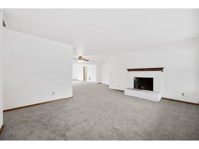 a view of empty room with a fireplace