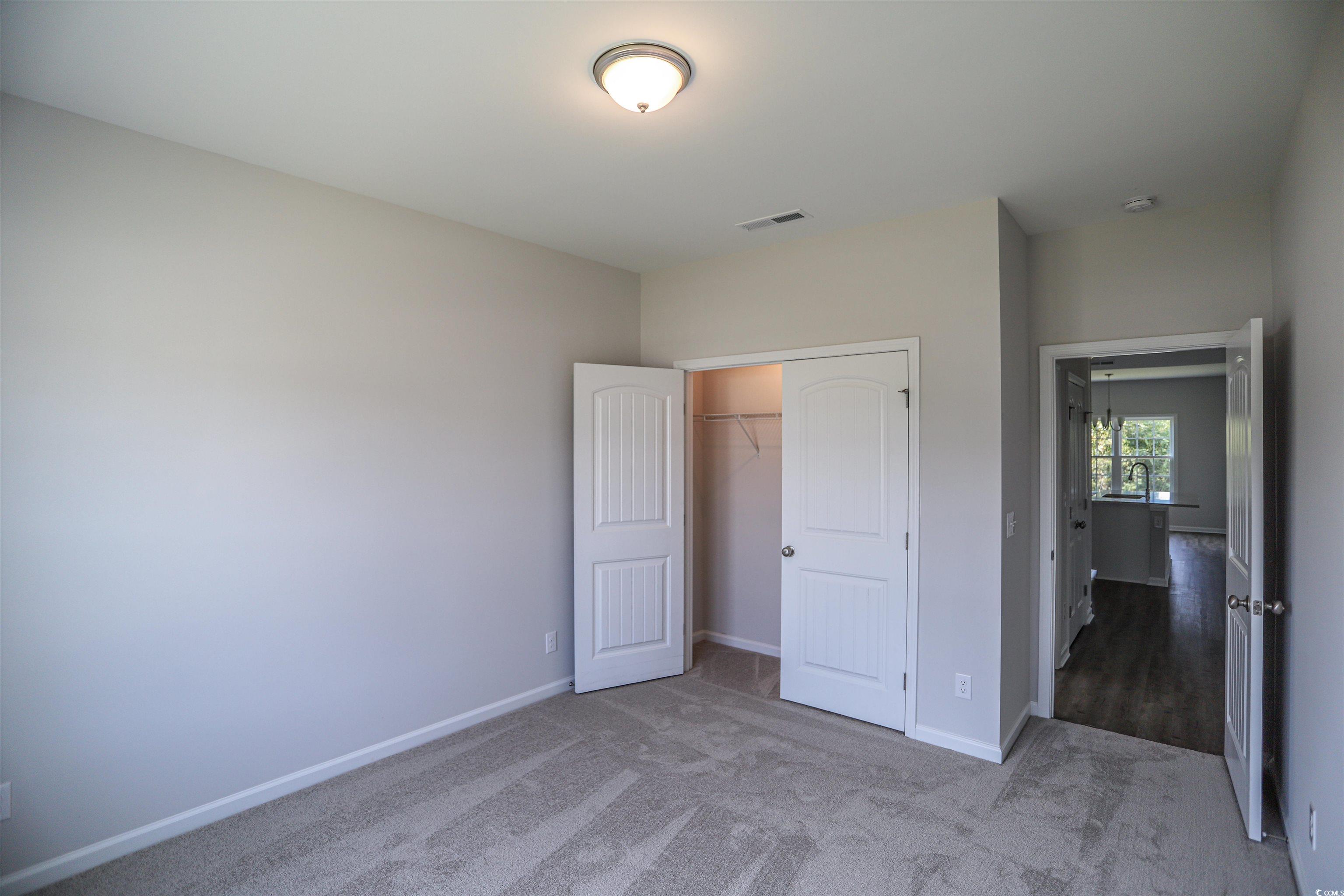 611 Bay Street Aynor, SC 29544 - Photo 9 of 12 Unfurnished bedroom with light colored carpet and a closet