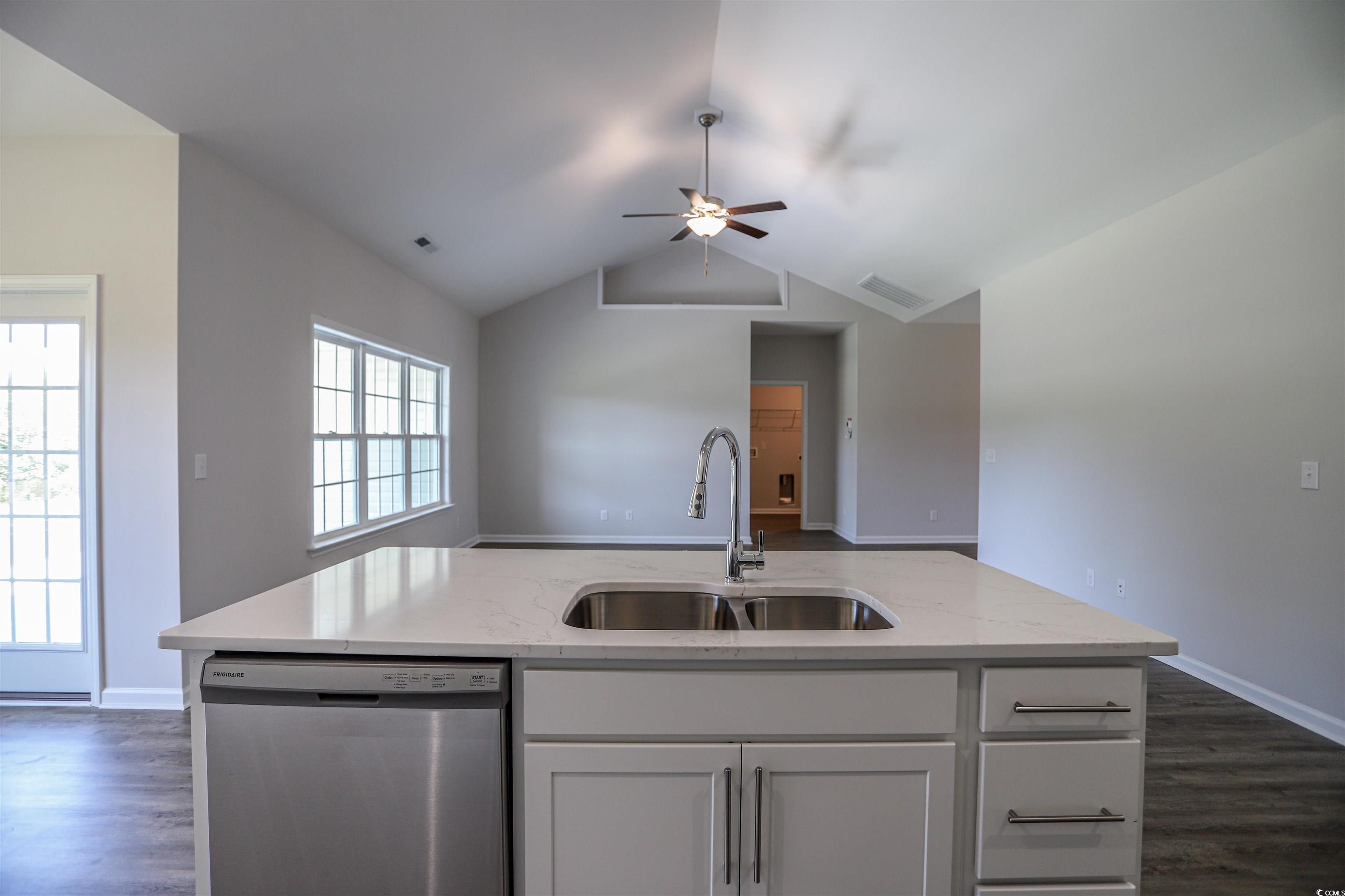 611 Bay Street Aynor, SC 29544 - Photo 2 of 12 Kitchen featuring stainless steel dishwasher, dark wood-style flooring, white cabinetry, a ceiling fan, and lofted ceiling