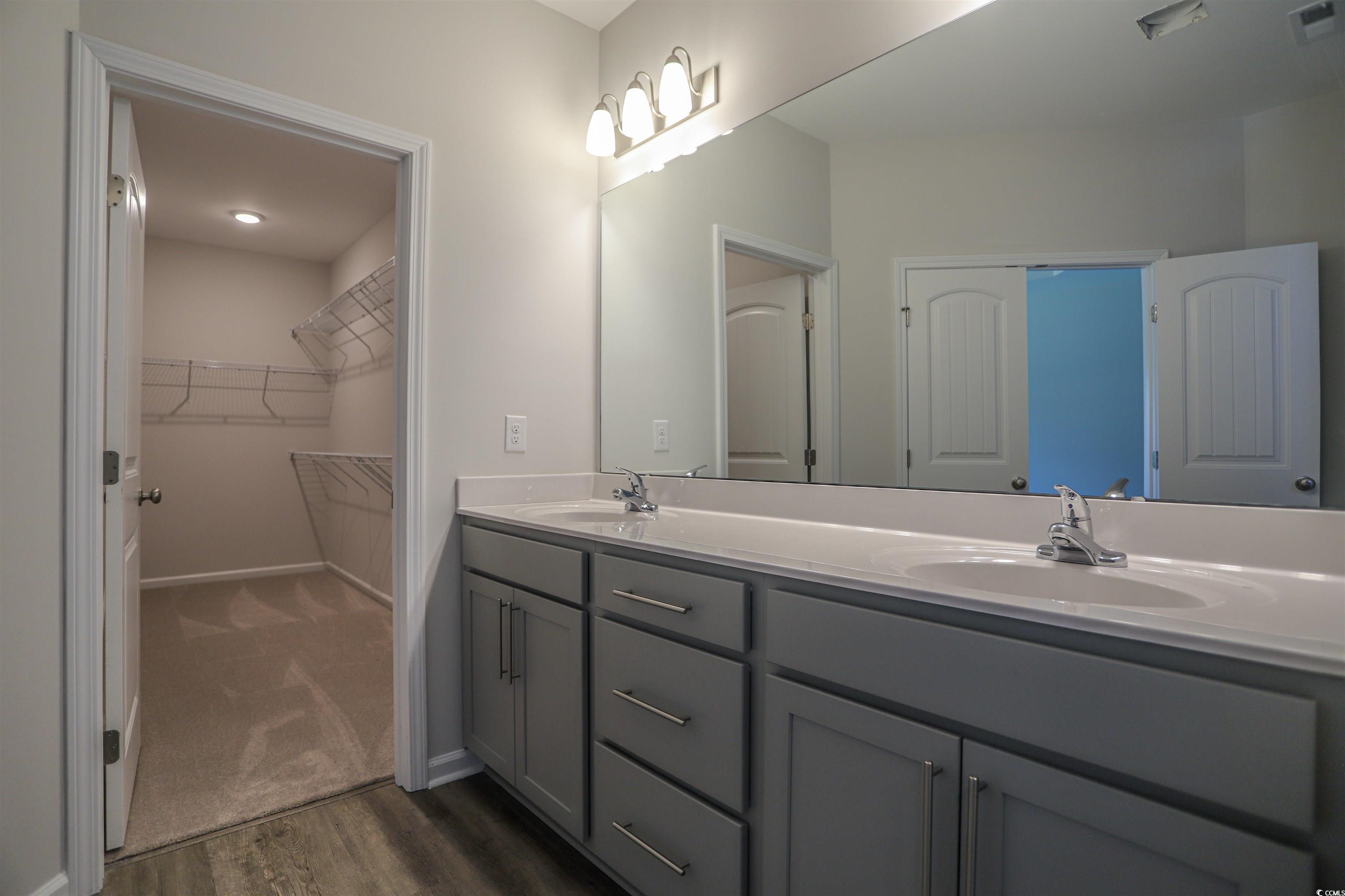 611 Bay Street Aynor, SC 29544 - Photo 5 of 12 Full bath with dark wood-type flooring, double vanity, and a walk in closet