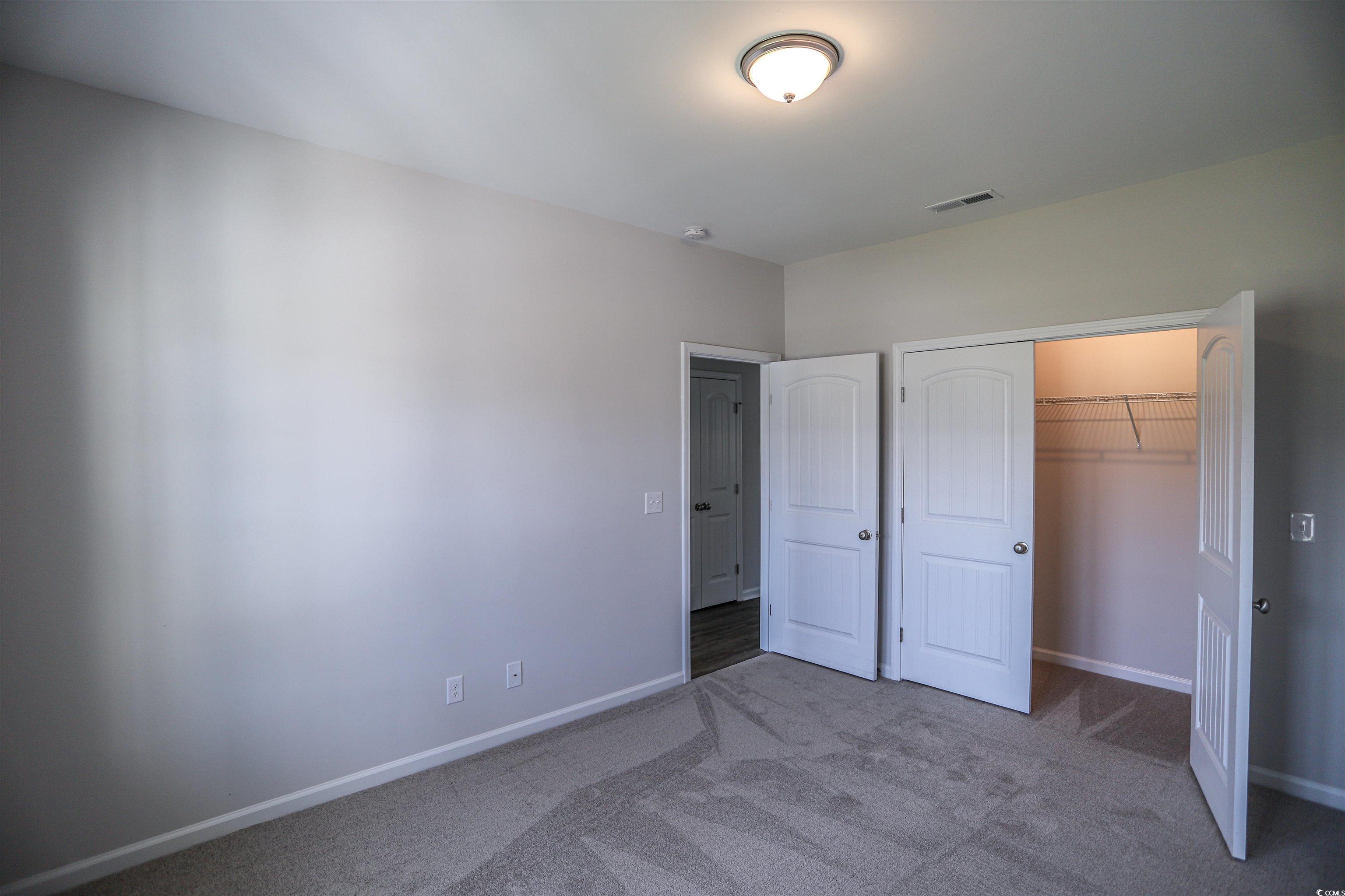611 Bay Street Aynor, SC 29544 - Photo 7 of 12 Unfurnished bedroom with carpet flooring and a closet