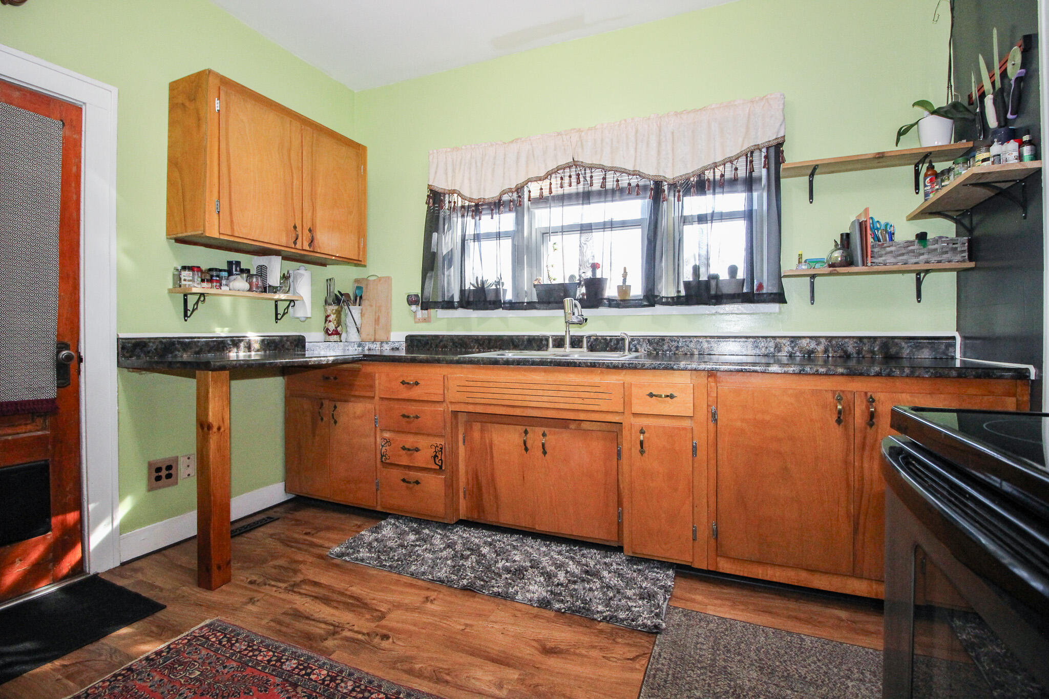 1765 Tower Street Chesterton, IN 46304 - Photo 11 of 27 a kitchen with granite countertop white cabinets and white appliances
