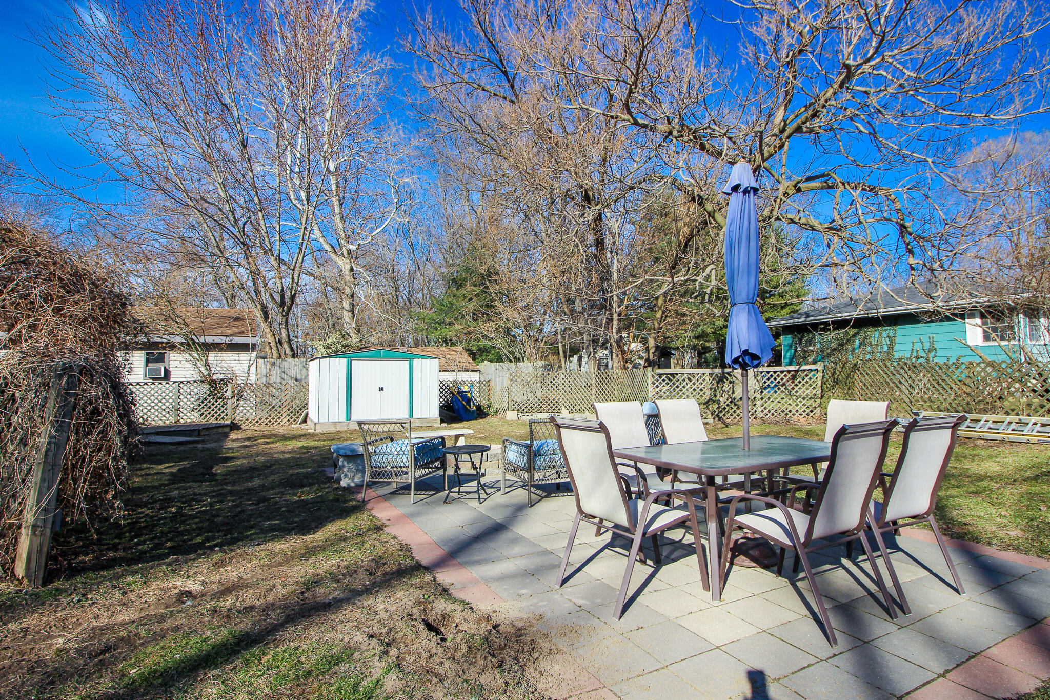 1765 Tower Street Chesterton, IN 46304 - Photo 26 of 27 a view of a patio with table and chairs with wooden fence and floor