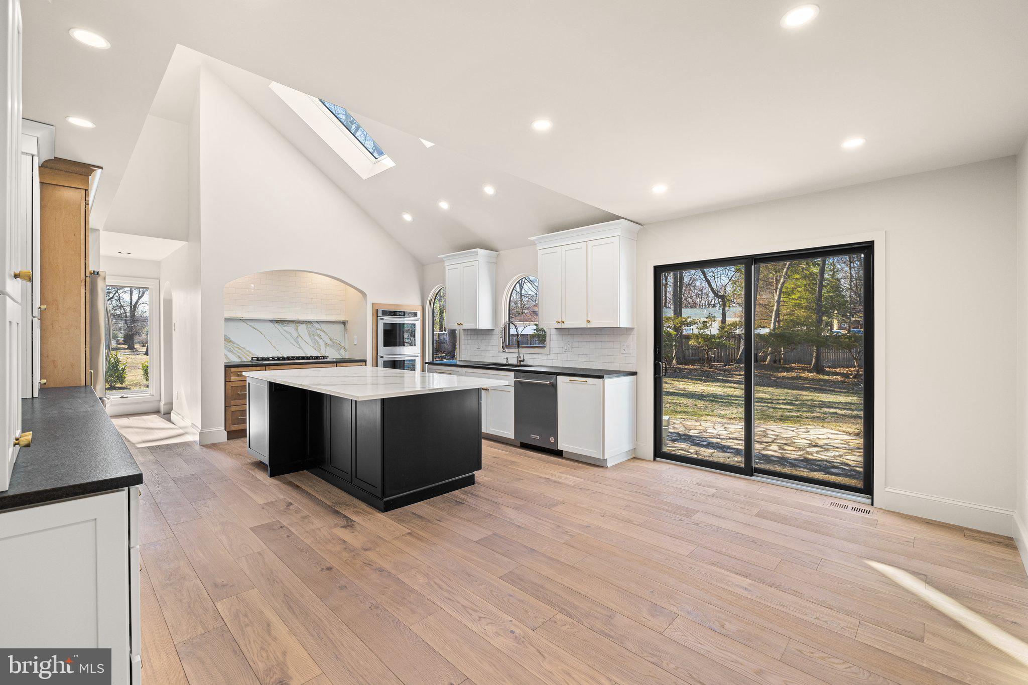 1555 Beechnut Circle Ambler, PA 19002 - Photo 28 of 58 a large white kitchen with wooden floors and a fireplace