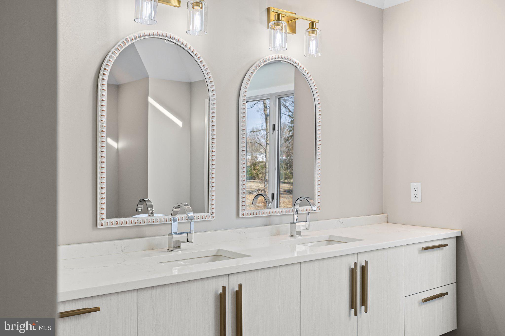 1555 Beechnut Circle Ambler, PA 19002 - Photo 35 of 58 a bathroom with a double vanity sink and a mirror