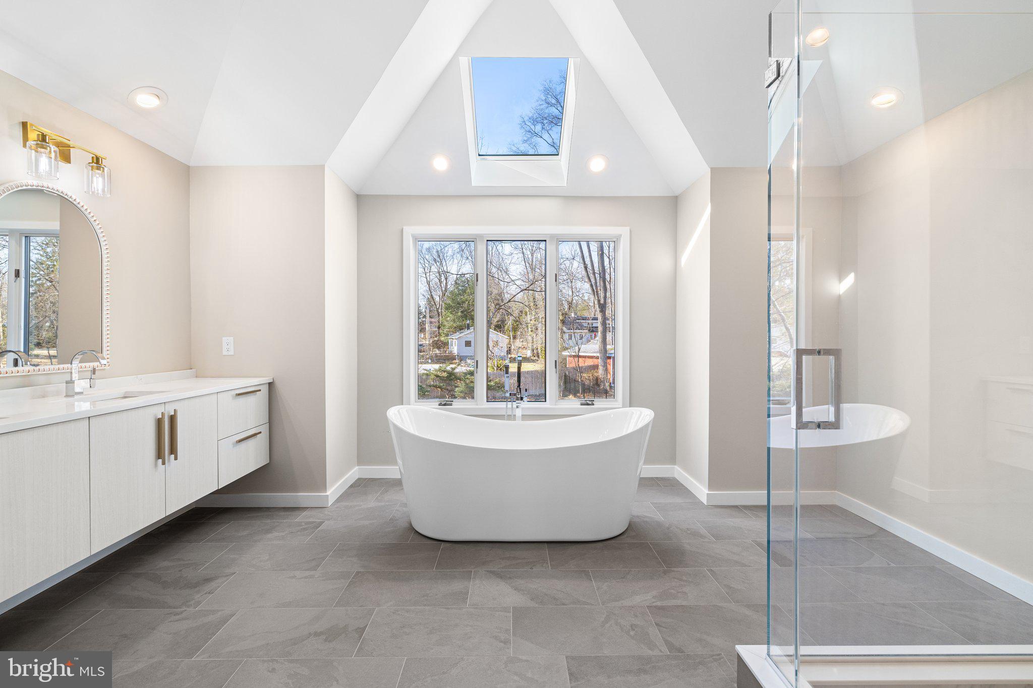 1555 Beechnut Circle Ambler, PA 19002 - Photo 39 of 58 a spacious bathroom with a double vanity sink a mirror and a bathtub
