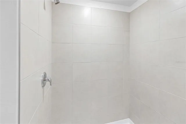 a bathroom with a granite countertop sink and white cabinets