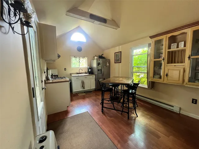 a kitchen with sink cabinets and wooden floor