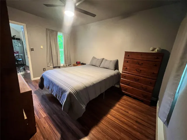 a bedroom with a bed and a dresser