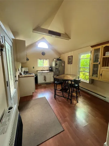a dining room with furniture and wooden floor
