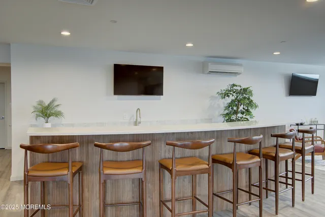 a living room with furniture kitchen view and a table