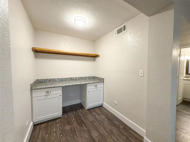 a view of cabinets and wooden floor