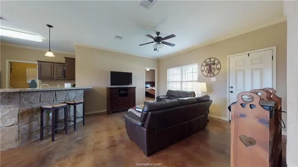 a living room with furniture and a flat screen tv