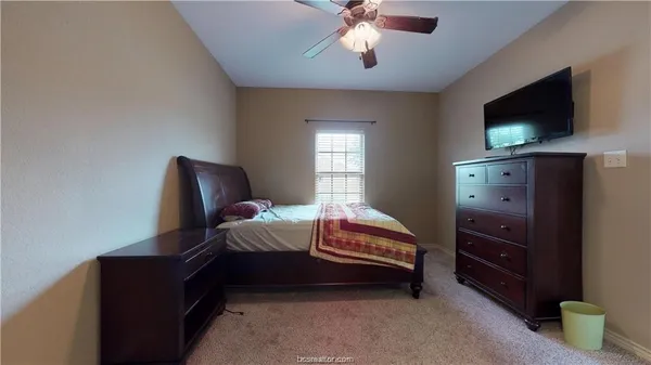 a bedroom with furniture and a flat screen tv