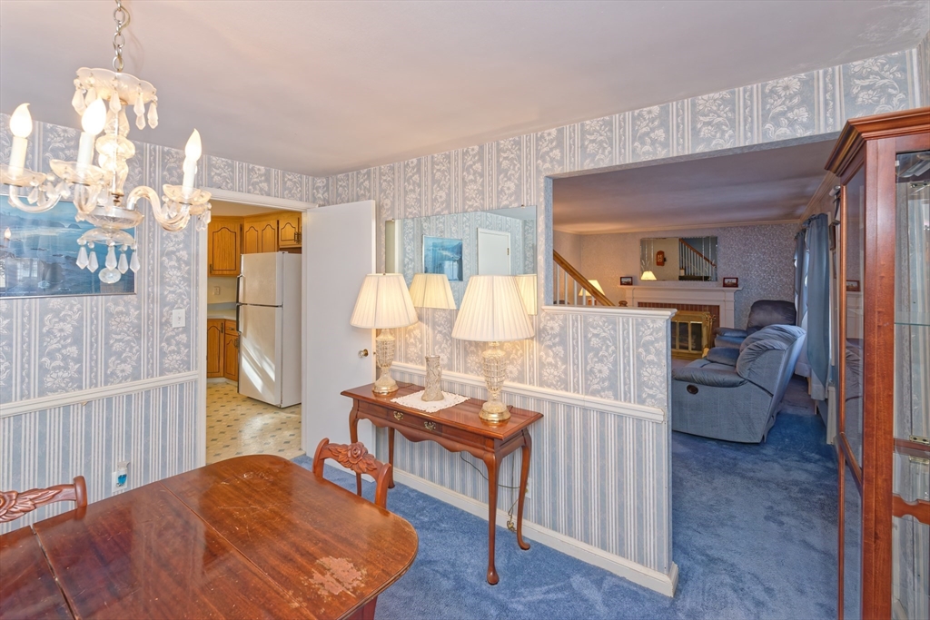17 Blackman Road Canton, MA 02021 - Photo 8 of 36 a living room with furniture a dining table and a chandelier