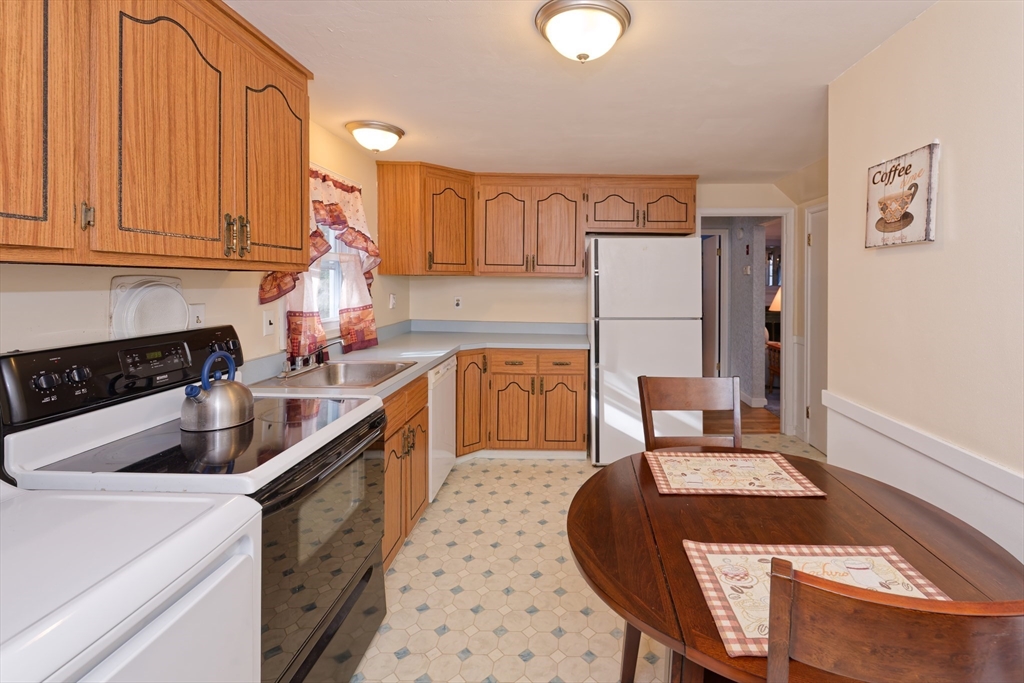 17 Blackman Road Canton, MA 02021 - Photo 10 of 36 a kitchen with a stove a sink and a refrigerator