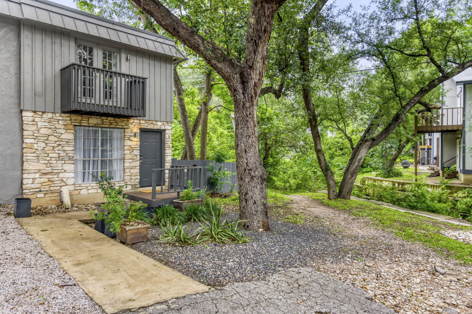 1912 Lightsey Road, Unit 6 Austin, TX 78704 - Photo 2 of 27 a front view of a house with garden