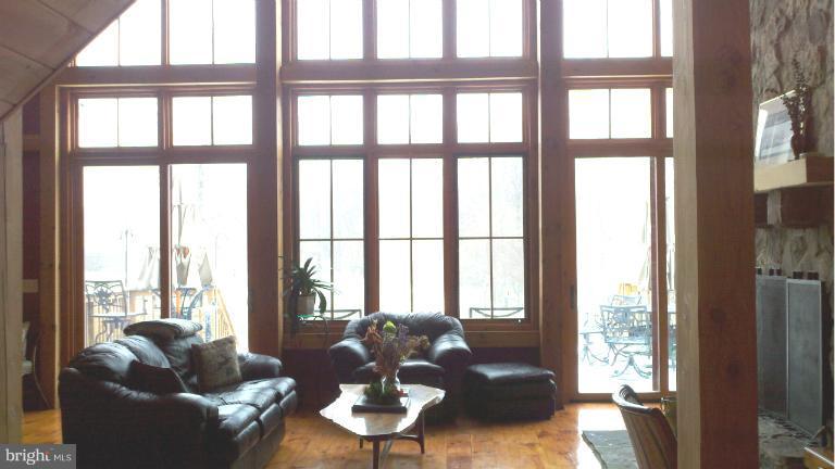 20163 Unison Road Round Hill, VA 20141 - Photo 9 of 20 a living room with furniture and floor to ceiling windows