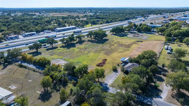 an aerial view of residential houses with outdoor space and river