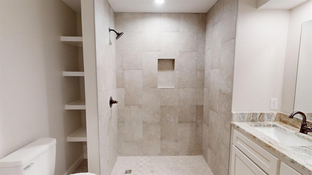 1110 Mill Run Road Athens, TX 75751 - Photo 26 of 32 a bathroom with a granite countertop sink toilet and shower