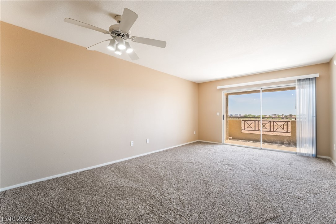 8070 West Russell Road, Unit 2024 Las Vegas, NV 89113 - Photo 5 of 19 A spacious room offers comfortable carpeted floors and a private balcony with scenic views.
