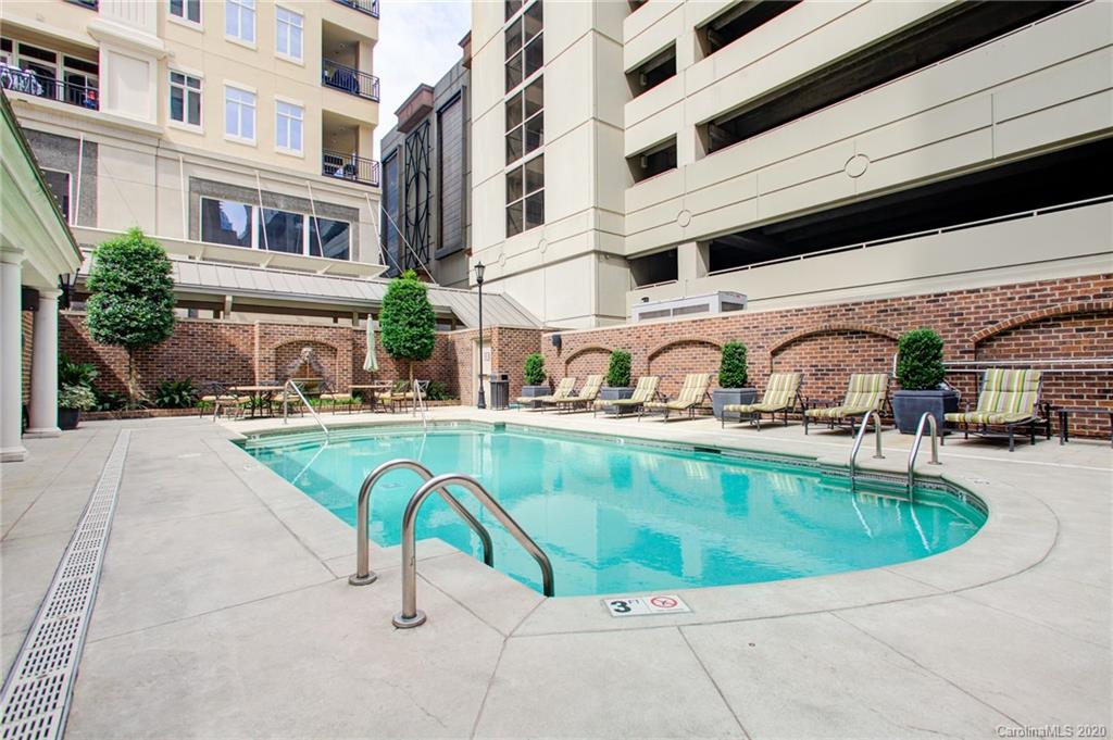 230 South Tryon Street, Unit 305 Charlotte, NC 28202 - Photo 2 of 32 a view of a swimming pool with a lounge chair