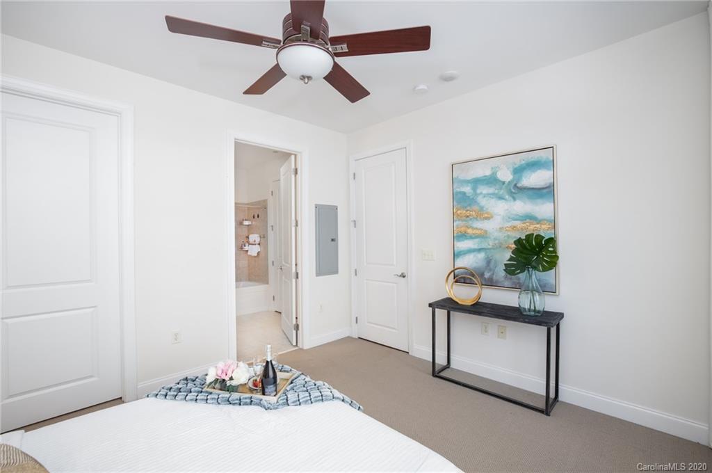 230 South Tryon Street, Unit 305 Charlotte, NC 28202 - Photo 11 of 32 a living room with furniture and a potted plant
