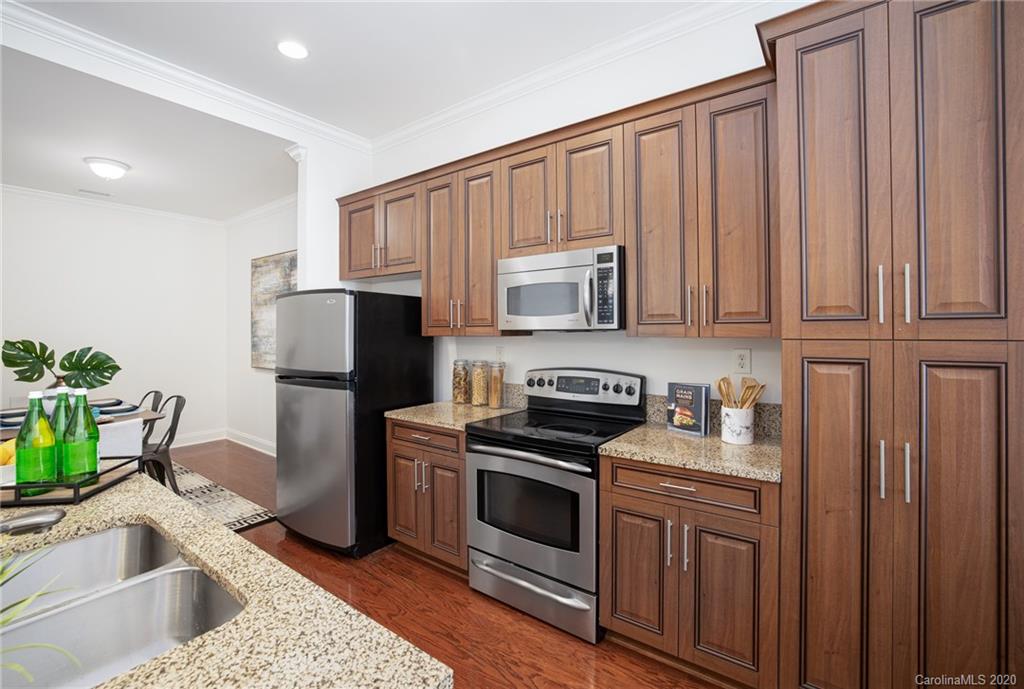 230 South Tryon Street, Unit 305 Charlotte, NC 28202 - Photo 13 of 32 a kitchen with a sink stove and refrigerator