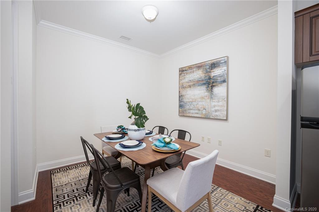 230 South Tryon Street, Unit 305 Charlotte, NC 28202 - Photo 20 of 32 a view of a dining room with furniture and window