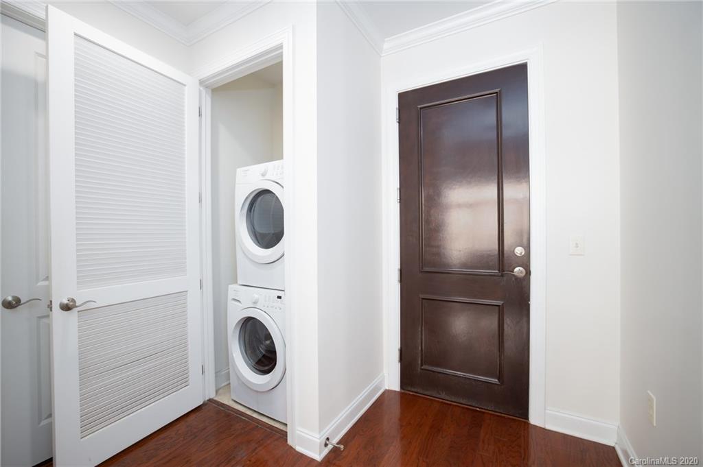 230 South Tryon Street, Unit 305 Charlotte, NC 28202 - Photo 21 of 32 a view of a hallway with washer and dryer