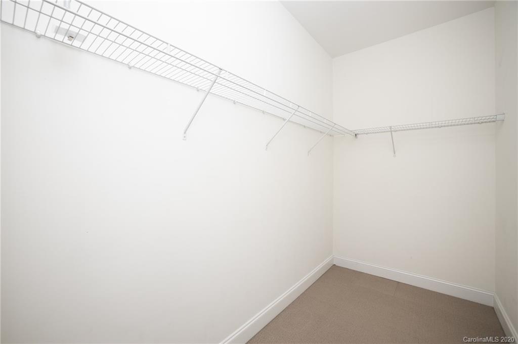 230 South Tryon Street, Unit 305 Charlotte, NC 28202 - Photo 22 of 32 a view of a room with racks on the wall
