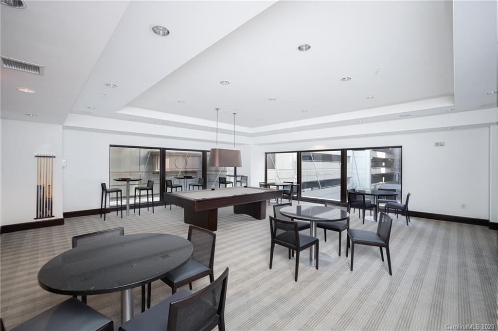 230 South Tryon Street, Unit 305 Charlotte, NC 28202 - Photo 25 of 32 a view of a dining room with furniture window and wooden floor