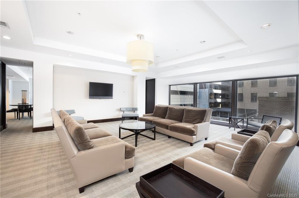 230 South Tryon Street, Unit 305 Charlotte, NC 28202 - Photo 27 of 32 a living room with furniture and a large window