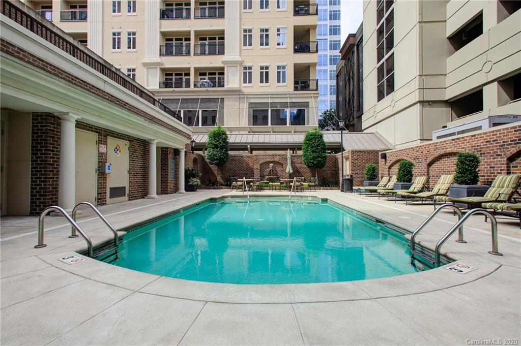 230 South Tryon Street, Unit 305 Charlotte, NC 28202 - Photo 30 of 32 a view of a swimming pool with a lounge chair