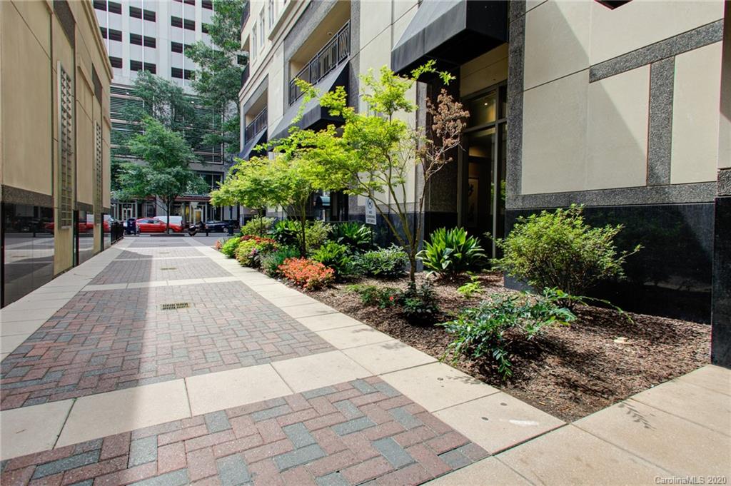 230 South Tryon Street, Unit 305 Charlotte, NC 28202 - Photo 31 of 32 a view of a pathway with house on both side