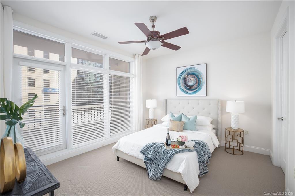 230 South Tryon Street, Unit 305 Charlotte, NC 28202 - Photo 7 of 32 a bedroom with a bed and a window