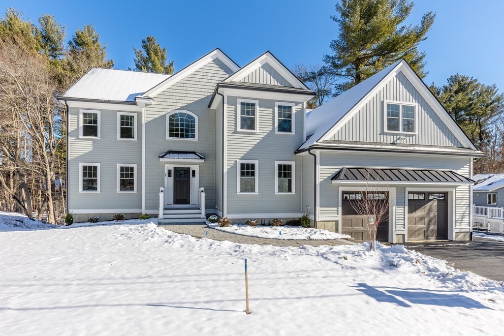 24 Hart Street Burlington, MA 01803 - Photo 1 of 42 a front view of a house with a yard and garage