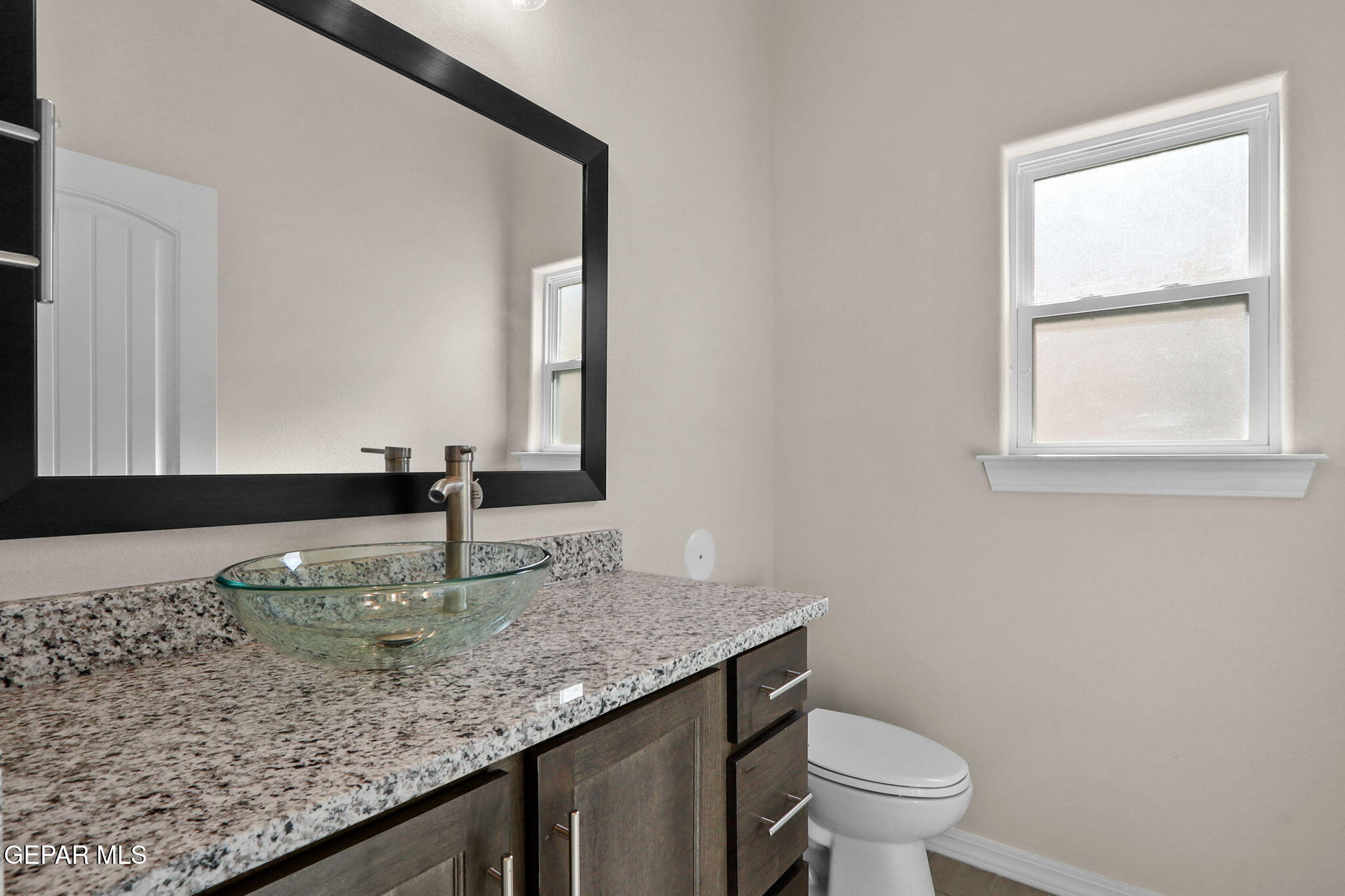 15313 Resolve Drive El Paso, TX 79938 - Photo 11 of 45 a bathroom with a granite countertop sink and a toilet