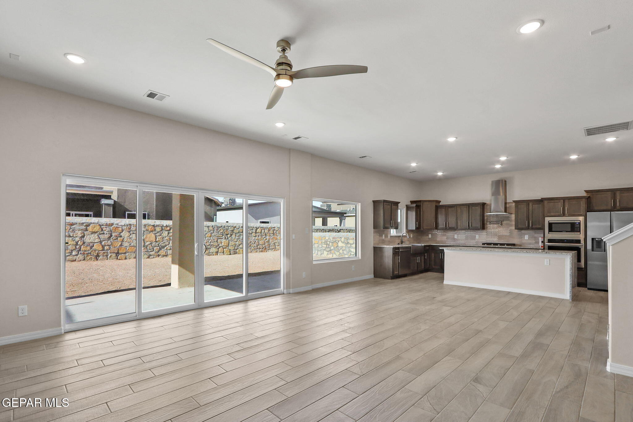 15313 Resolve Drive El Paso, TX 79938 - Photo 12 of 45 a large kitchen with stainless steel appliances wooden floor and a large window